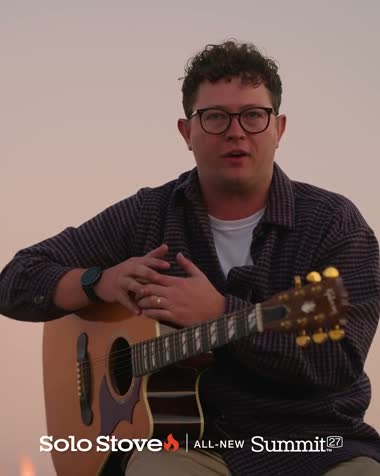 Guitar by the fire in the Solo Stove Summit ad