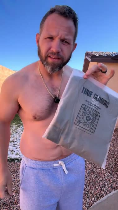 True Classic tee package held to camera in the ad